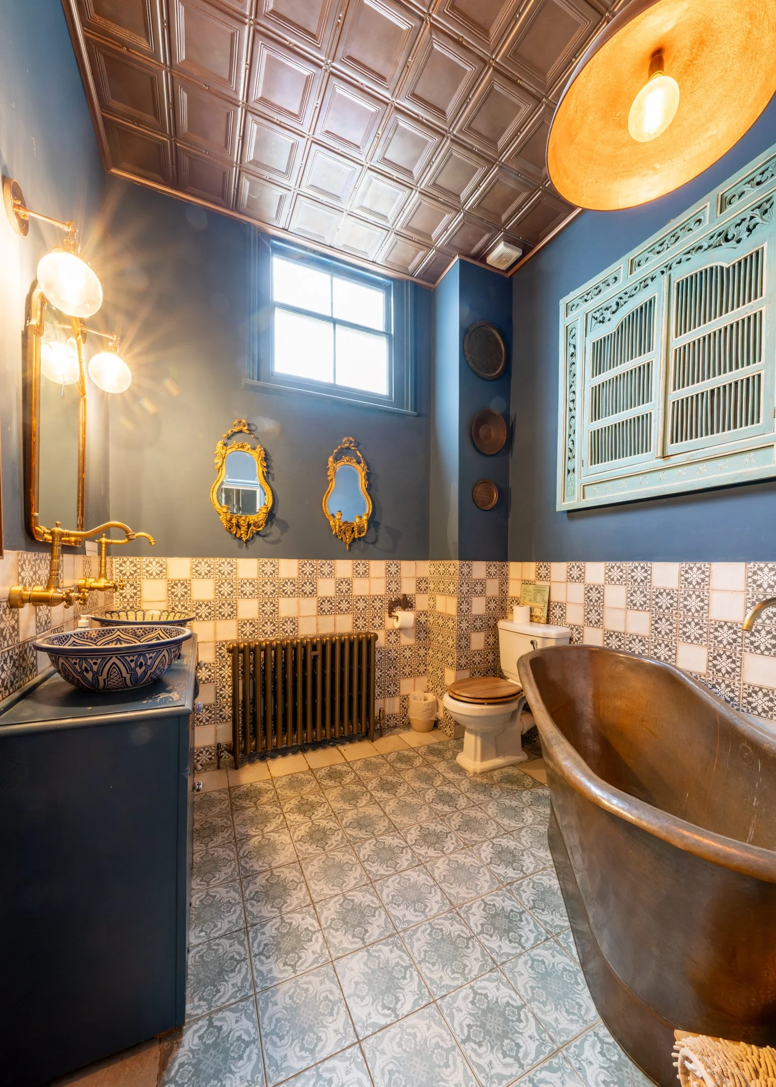 Bathroom detail — copper bath and brass fittings