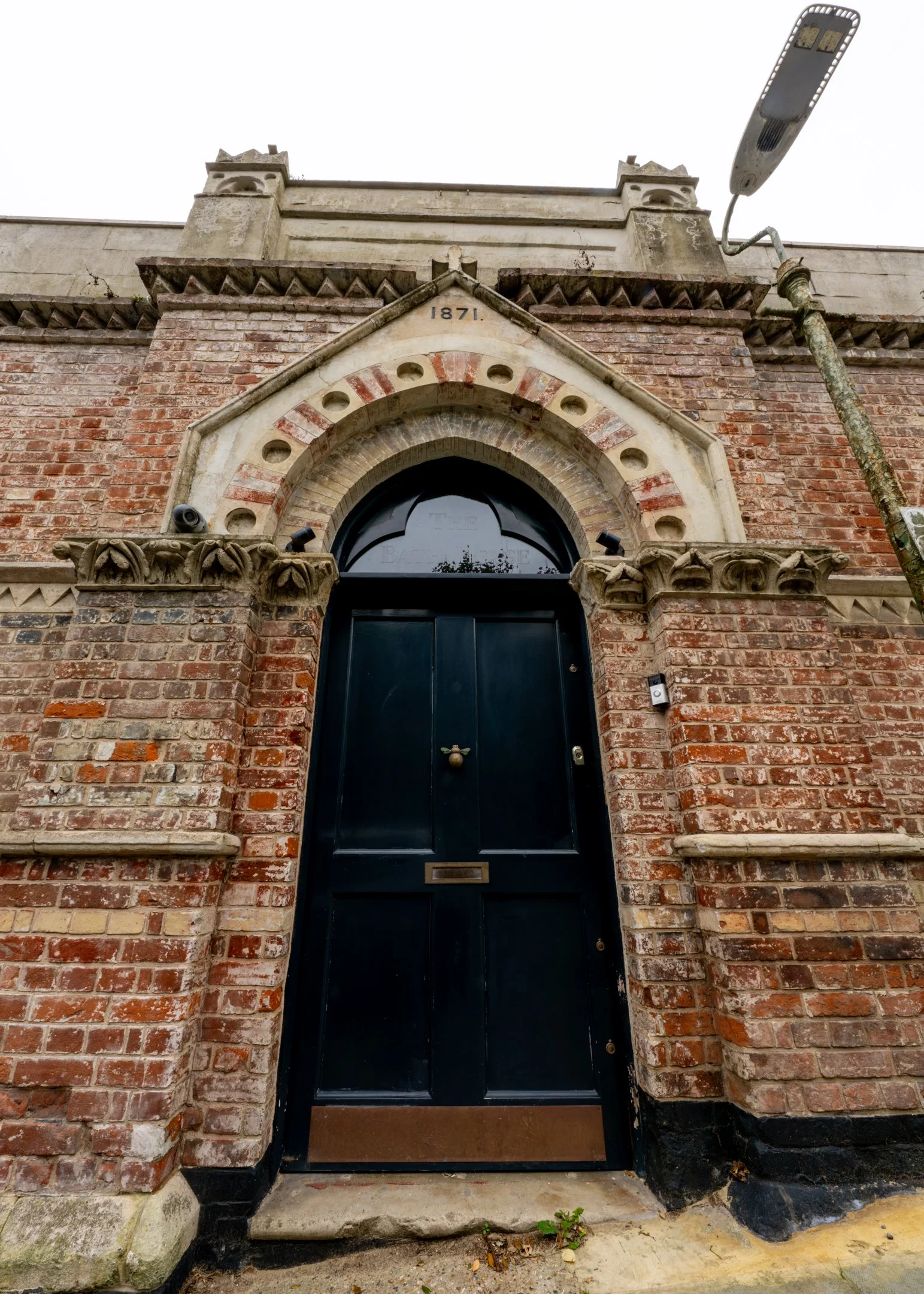 Close view of the 1871 date stone and pointed-arch entrance